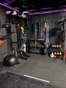 Well-equipped boxing and fitness studio with weights and resistance bands.
