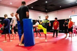 Children practicing martial arts in a training class at Lauzon MMA.