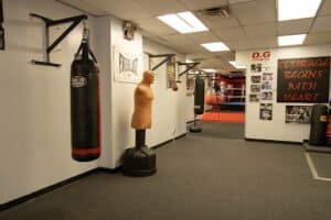 Boxing gym with punching bags and training equipment for boxing workouts.