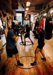 Boxing training session with trainers and fighters at Trinity Boxing Club.