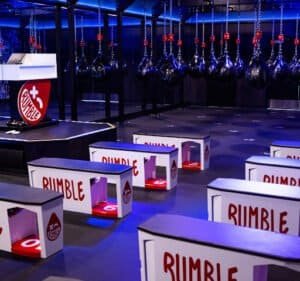 Boxing training area with punching bags and Rumble branding.