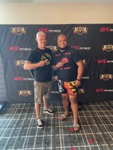 Two fighters posing with fists up at GT Fighting Academy event.