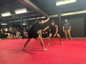 Two practitioners sparring in Brazilian Jiu Jitsu class at La Crosse gym.