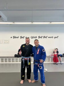 Two men in Brazilian Jiu-Jitsu gis smiling at Daniel Gracie Academy Northborough.