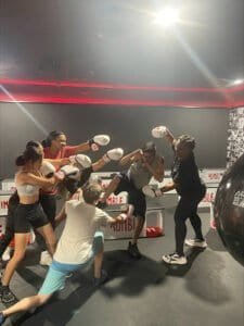 Group of people practicing boxing at Rumble Boxing gym.