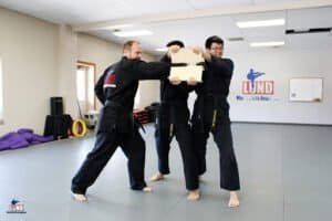 Martial arts students practicing self-defense techniques at Lund Martial Arts Academy.