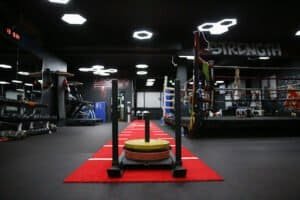 Empty boxing gym with training equipment and ring for Revolution Training.