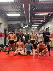 Group of fighters and trainers at Kaizen MMA Fairfax gym.