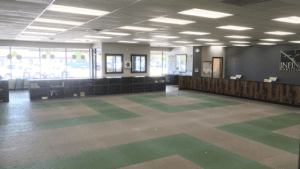 Spacious martial arts training area with mats and reception desk in Oregon.