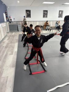Young children practicing martial arts in a training class at Action Karate Oreland.
