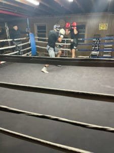 Boxers sparring in a boxing ring during training session at Washington Boxing Academy.