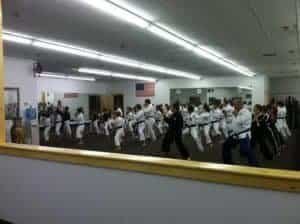 Martial arts students practicing in a large training room at Jukado.