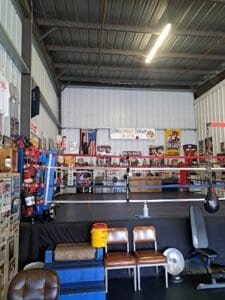 Indoor boxing gym with training equipment and boxing ring at Northside Boxing Club.