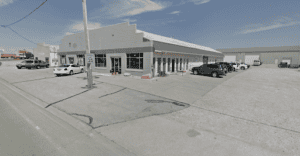 Exterior view of RoundKick Gym at Carroll Club with parking lot.