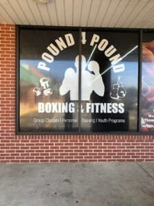 Boxing gym sign with logo and boxing gloves at Pound 4 Pound Fitness.