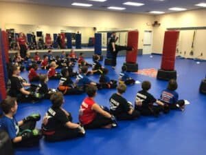 Children participating in a kickboxing class at Find Boxing gym.