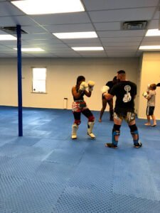 Boxers practicing sparring in a boxing gym at SMT Academy.