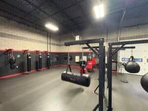 Indoor boxing gym with punching bags, speed bags, and training equipment.