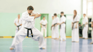 Martial arts students practicing karate techniques in dojo.