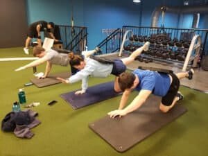 People doing planks during a group fitness class at YSH Personal Training.