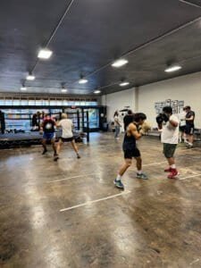 Boxing training session at St. Johns Boxing gym with multiple fighters practicing.