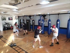 Boxers training with punching bags at R3 Boxing gym.