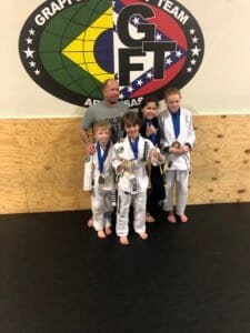 Young martial artists with medals at Pinnacle Martial Arts Academy.
