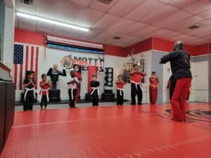 Children practicing martial arts under instructor at Matt Fields Martial Arts Academy.