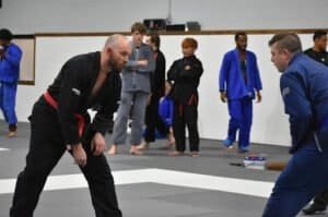 Martial arts practitioners practicing grappling techniques in a training session.