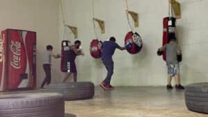 Group of people practicing boxing with punching bags at Pueblo Boxing Tre4.