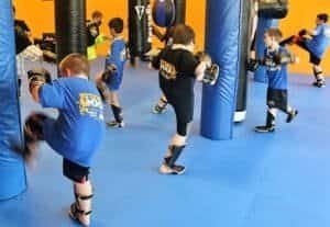 Children practicing boxing techniques in a training class at Rothwell MMA.
