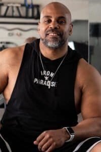 Fitness trainer at Right Hook Fitness Academy smiling confidently.