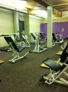 Various gym machines and equipment in a fitness center.