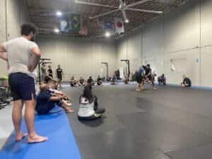 Students practicing Brazilian Jiu-Jitsu techniques in a training session at Gracie Apollo Beach.