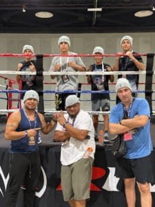 Boxers and trainers in training at Real Boxing Club gym.