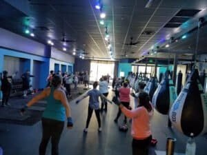 Group fitness class at RockBox Fitness Murfreesboro with punching bags and participants.
