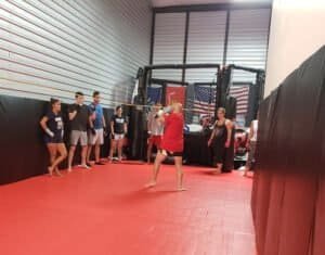 Women practicing MMA in a training cage at Ronin MMA Texas.