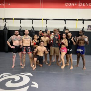 Group of diverse boxers and trainers at Ohana Academy HQ gym.