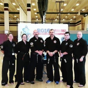 Martial arts team in uniform at Utah Valley event.