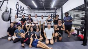 Group of diverse kickboxers at ŌKA Kickboxing Club gym.