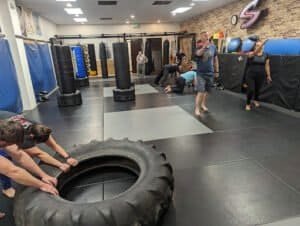 Students practicing martial arts techniques in a training facility.