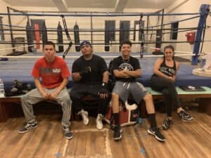 Group of young boxers resting after training at Guv'nors Boxing Club.