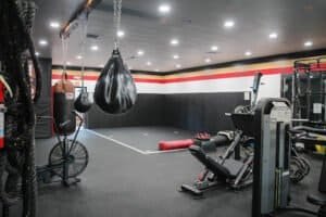 Boxing gym with punching bags and workout equipment at HardWorx Fitness.