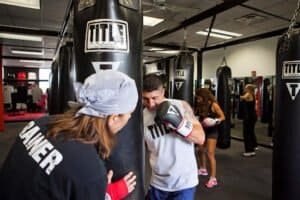 People practicing boxing at TITLE Boxing Club Springfield gym.