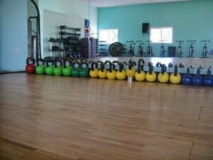 Fitness studio with kettlebells, bikes, and workout equipment in Cape Cod.