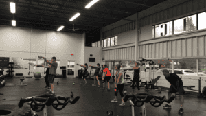 People participating in a group workout session at a gym.