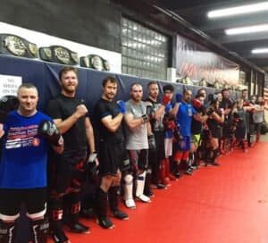 Boxers lined up in training gear at Pennsylvania Combat Sports gym.