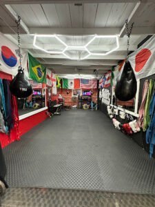 Boxing gym with flags, punching bags, and training gear for boxing training.