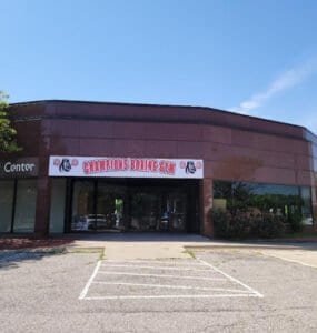 Exterior of Champions Boxing Gym with signage and parking lot.