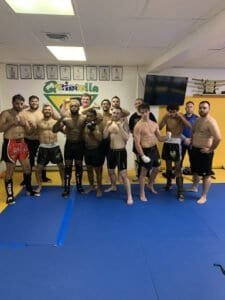 Group of fighters in training at Quintella MMA gym.